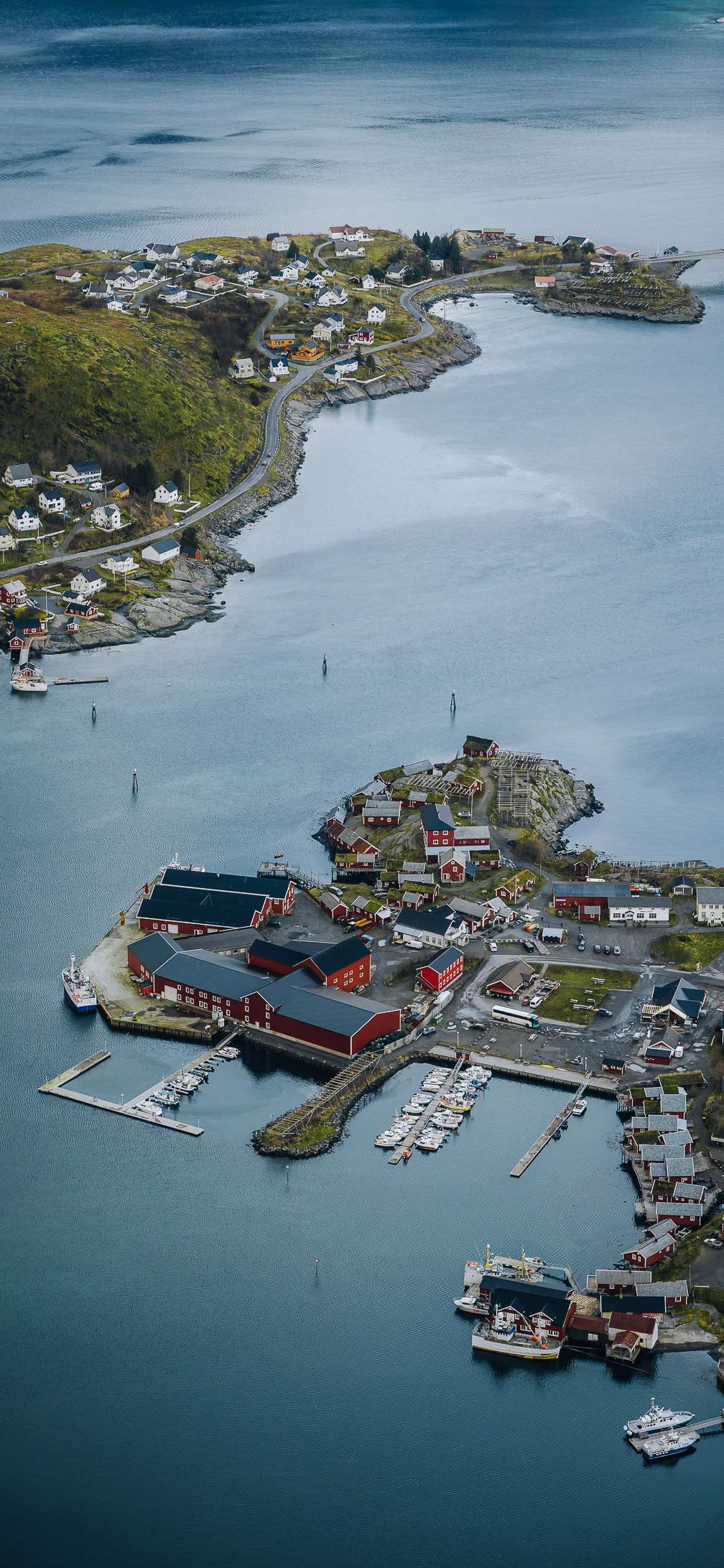 Coastal town: The image shows a coastal town with numerous buildings, including houses, warehouses, and a marina