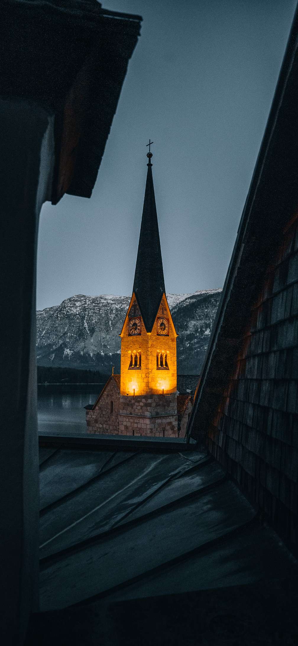 Scenic Serenity: Hallstatt Church Amidst Snow-Capped Mountains